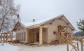 Construction of frame wooden house on the background of a pine forest, winter period Royalty Free Stock Photo