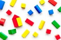 Construction game for kids. Wooden building blocks, toy bricks on white background top view Royalty Free Stock Photo