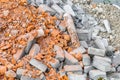 Construction garbage. A pile of red broken bricks, debris of concrete and rubble. Dust, dirt and stones after the Royalty Free Stock Photo