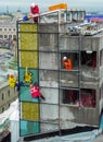 Construction of a glass wall, crane and industrial climbers.