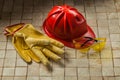 Construction gloves goggles and red helmet on woodn background Royalty Free Stock Photo