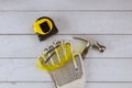 Construction hammer and set of protective gloves workwear safety glasses tape measure on wooden board Royalty Free Stock Photo