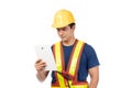 Construction handsome man worker in yellow helmet and reflective vest and using tablet for check work with team staff isolated on Royalty Free Stock Photo