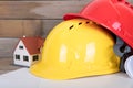 Construction hard hat and drawings and a small house model Royalty Free Stock Photo