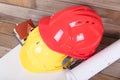 Construction hard hat and drawings and a small house model Royalty Free Stock Photo