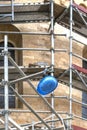 Construction helmet hangs on scaffolding