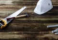 Construction helmet with saw, hammer and ruler for builder concept Royalty Free Stock Photo