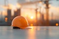 Construction Helmet on Site at Sunset with Cityscape Reflection Royalty Free Stock Photo