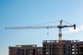 Construction of high panel building. Construction crane on blue sky daytime: Ufa, Russia - May 30, 2019