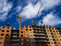 Construction of a high-rise building. Cranes construction hauling cargo Royalty Free Stock Photo