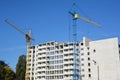 Construction of a high-rise building with a construction cranes silhouettes Royalty Free Stock Photo