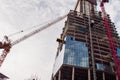 Construction of high-rise building. Construction cranes and skyscraper