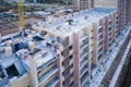 Construction of a high-rise building. A team of construction masons lays out the walls of bricks Royalty Free Stock Photo