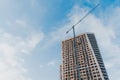 Construction activity of modern building in the city with turret slewing crane in daytime