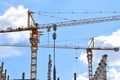 The construction of high-rise buildings, the supply of building materials with the help of a crane Royalty Free Stock Photo