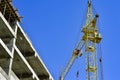 The construction of high-rise buildings, the supply of building materials with the help of a crane Royalty Free Stock Photo