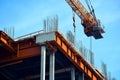 Construction of a highway bridge featuring steel beams and columns with crane lifting materials Royalty Free Stock Photo