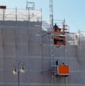 Construction hoist elevator on a facade under renovation. Royalty Free Stock Photo