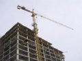 Construction hoisting crane above building house