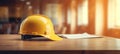 Construction house concept - Repair work.Yellow hard hat on wooden table in office.