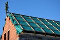 Construction of house is finished on each floor with a green tree branch. vapor permeable insulation under battens on which roof t