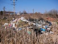 Construction and household waste near roadside, conceptual human negligence image.