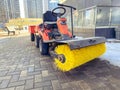 Construction of houses. cleaning the workplace with a special car with a huge, brush for cleaning asphalt. driver control car