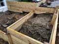 Construction if a small residential retaining wall and planter bed from timber material