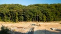 Construction industrial polluted environment space aerial photography with tractor and excavator in building territory surrounded