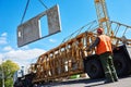 Construction industrial worker operating hoisting process of concrete slab