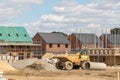 Construction industry building site. Houses at various stages of