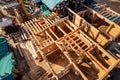 Construction industry concept. Timber wooden frame of house from bar, foundations of villas. Aerial top view Royalty Free Stock Photo