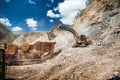 Mining and construction industry - industrial excavator loading rocks and gravel into machinery Royalty Free Stock Photo