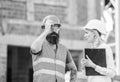 Construction inspection, corrections and fines. Safety inspector concept. Discuss progress project. Inspector and Royalty Free Stock Photo