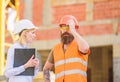 Construction inspection, corrections and fines. Safety inspector concept. Discuss progress project. Inspector and Royalty Free Stock Photo