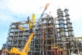 Construction and installation work with a powerful construction crane of a large new industrial oil refining petrochemical