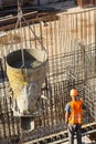 Construction of a large commercial building. Construction worker ready fill formwork by cement and concrete over bound reinforceme