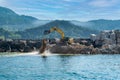 Construction machine builds breakwater, Amasra, Black Sea, Turkey