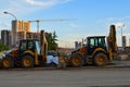 Construction machinery builds in the city center. excavators for excavating sand and making foundations. yellow big construction