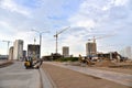 Construction machinery and Equipment on road work. Excavator on earthmoving at construction site. Tower cranes in action on blue Royalty Free Stock Photo