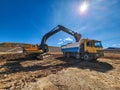 Construction machinery in the process of loading and transporting materials Royalty Free Stock Photo