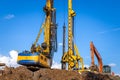 Construction machinery at the construction site. BAUER BG 36 rotary drilling rigs and excavator building a foundation