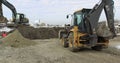 Construction Machinery At Work On Building A House. Different Types Of Tractors And Excavators Prepare The Soil For