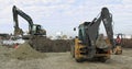 Construction Machinery At Work On Building A House. Different Types Of Tractors And Excavators Prepare The Soil For