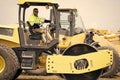 construction machinery worker at roller. machinery in a manufacturing industry with construction worker outdoor