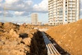 Construction of main water supply pipeline. Laying underground storm sewers at construction site Royalty Free Stock Photo