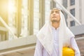 Construction and maintenance concept, Arab Middle Eastern architect holding yellow helmet and checking tablet PC with city backgro Royalty Free Stock Photo