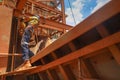 Construction maintenance worker wearing safety helmet, fall arrest harness clipping while working at height Royalty Free Stock Photo