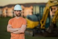 Construction man with excavator at industrial site. Worker in helmet build with bulldozer. Engineer work with builder Royalty Free Stock Photo