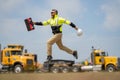 Construction man excited jump with helmet. Builder in helmet outdoor portrait. Worker in hardhat. Construction engineer